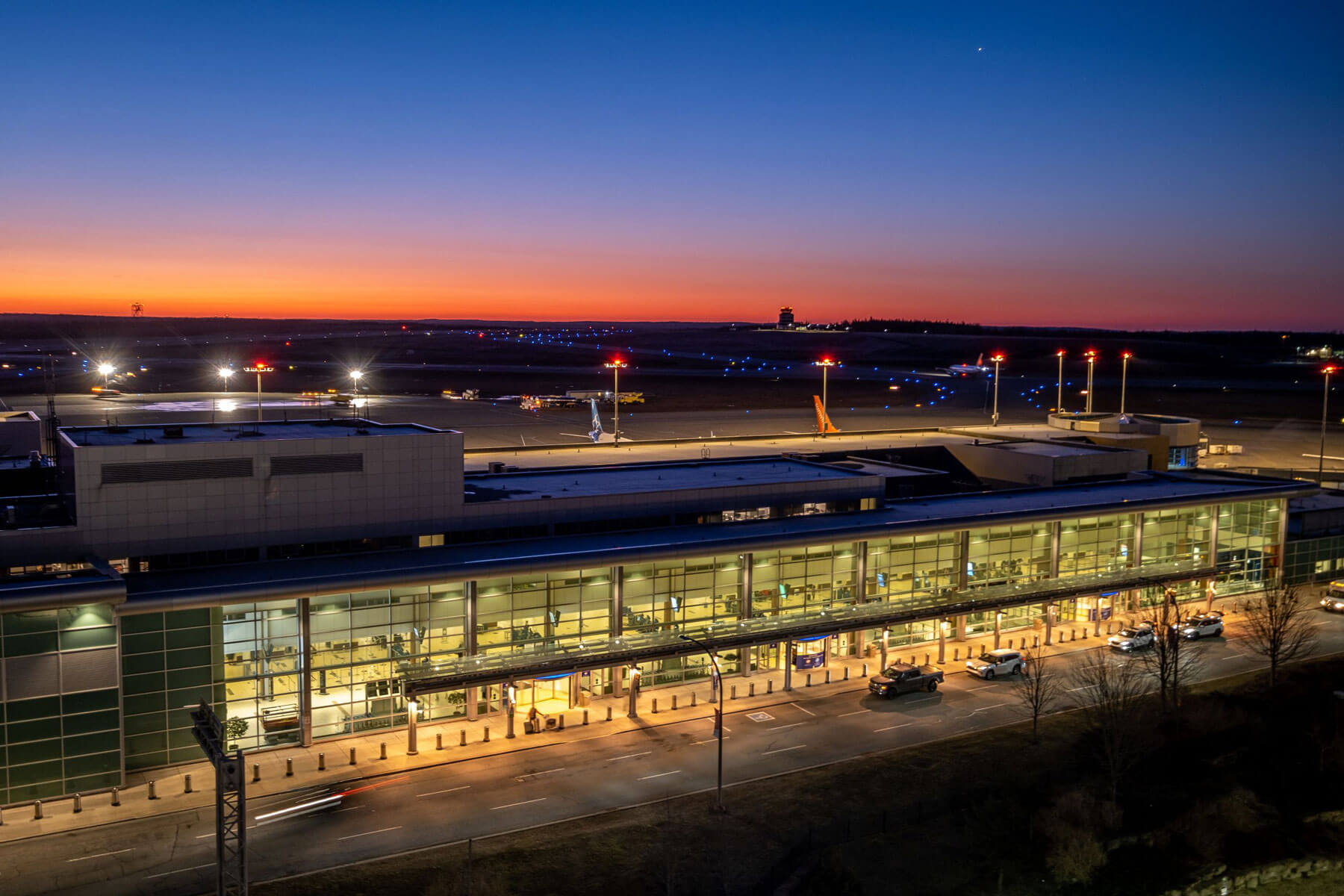 Airport LED lighting 2022 Alt Text: An aerial of Halifax Stanfield International Airport during a vibrant sunset.