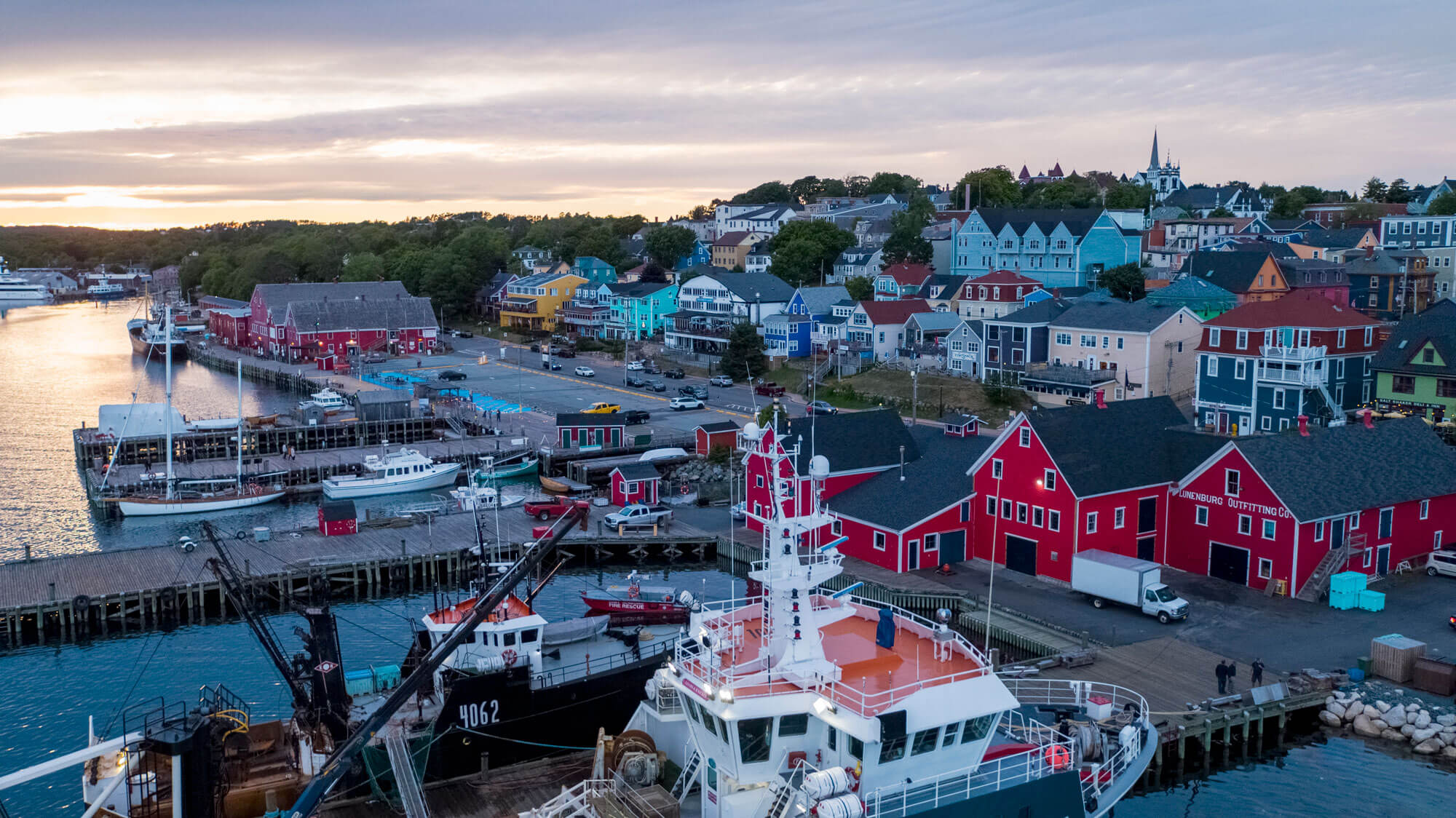 Aerial of Lunenburg's waterfront facing toward the city at sunset in winter.
